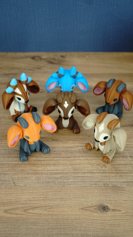 Six 3D printed Palia sernuk plush figures displayed together, featuring different color variants with large ears, small horns, and sitting poses.