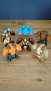 Six 3D printed Palia sernuk plush figures displayed together, featuring different color variants with large ears, small horns, and sitting poses.