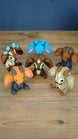 Six 3D printed Palia sernuk plush figures displayed together, featuring different color variants with large ears, small horns, and sitting poses.