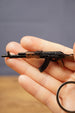 Detailed AK-74 rifle keyring displayed in hand with metal key loop, compact tactical shooter gift for gamers and collectors