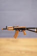 Close-up side view of the AKS-74U rifle keyring showing bronze magazine, black receiver and compact tactical gamer collectible design