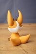 Ancient Kitsuu figure rear view showing orange curled tail, tall ears, white back head marking and smooth display finish