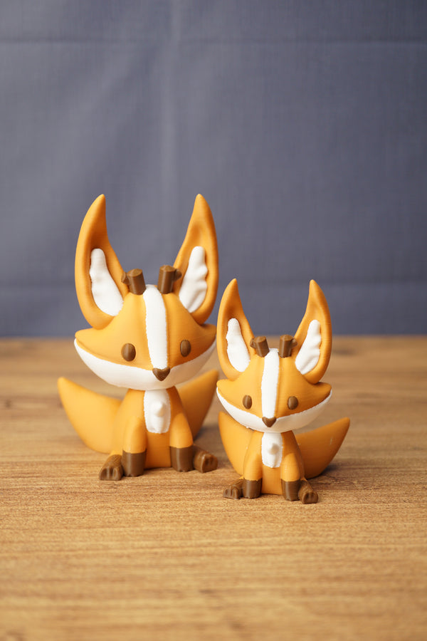 Ancient Kitsuu fox figures in two sizes with orange bodies, white face markings, brown details and large pointed ears