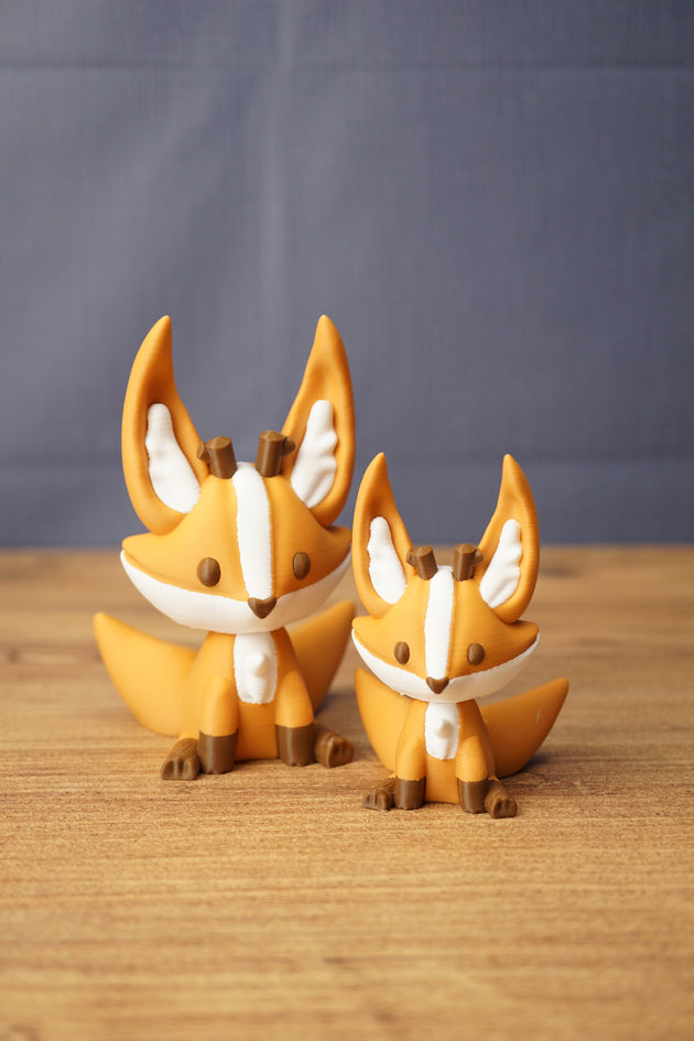 Ancient Kitsuu fox figures in two sizes with orange bodies, white face markings, brown details and large pointed ears