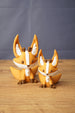 Ancient Kitsuu fox figures in two sizes with orange bodies, white face markings, brown details and large pointed ears