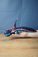 Marrowbreach inspired articulated creature figure resting on a hand, showing its 31 cm length, segmented body, fins and dark blue aquatic design.