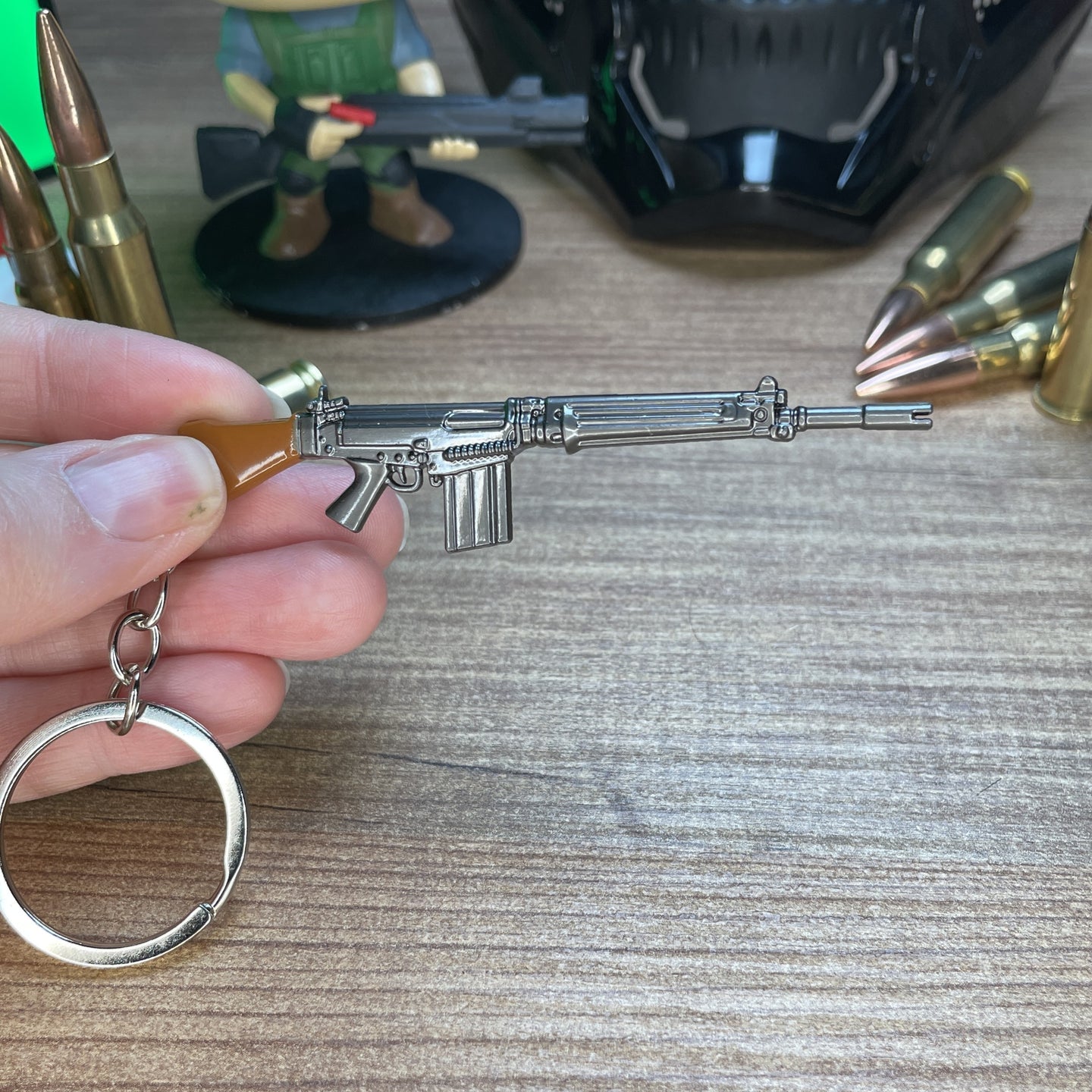Close-up of SA58 FAL keychain showing detailed receiver and gunmetal finish