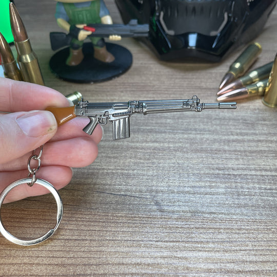 Close-up of SA58 FAL keychain showing detailed receiver and gunmetal finish