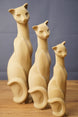Three stylized beige cat figurine replicas in different sizes, showing curved tails, long necks, and visible 3D printed layer texture.