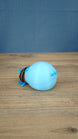 Rear view of the blue glow lantern bug plush showing its rounded blue body and small tail details.
