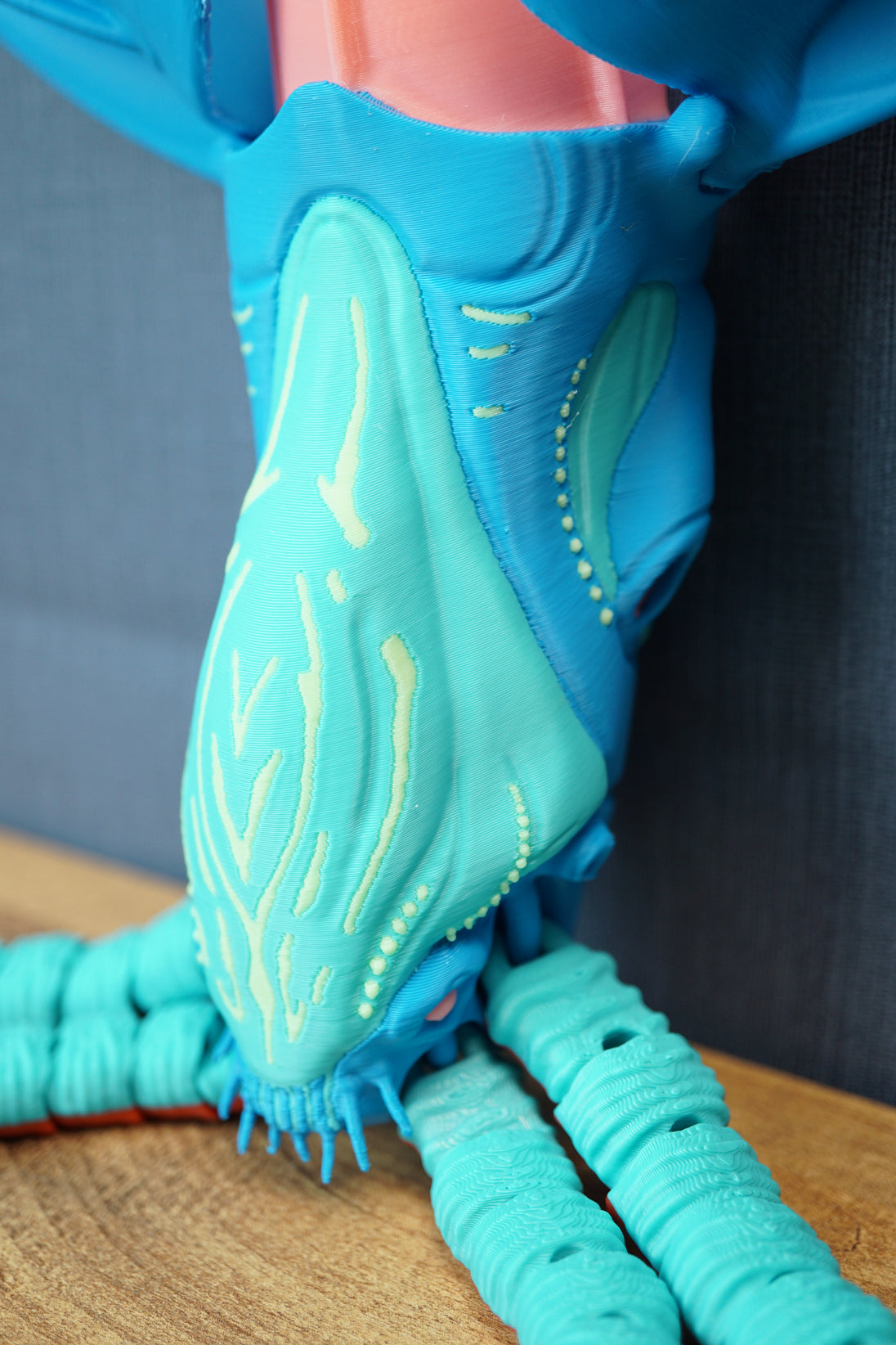 Detailed side close-up of Collector Leviathan face, glow pattern, blue head armor, pink crest, and textured tentacles on display