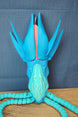 Front view of Collector Leviathan figure with raised blue fins, pink head crest, glowing face details, and long tentacles