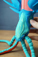 Close-up of Collector Leviathan head and face markings with hand support, showing glow details and textured tentacle segments