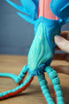 Close-up of Collector Leviathan head and face markings with hand support, showing glow details and textured tentacle segments