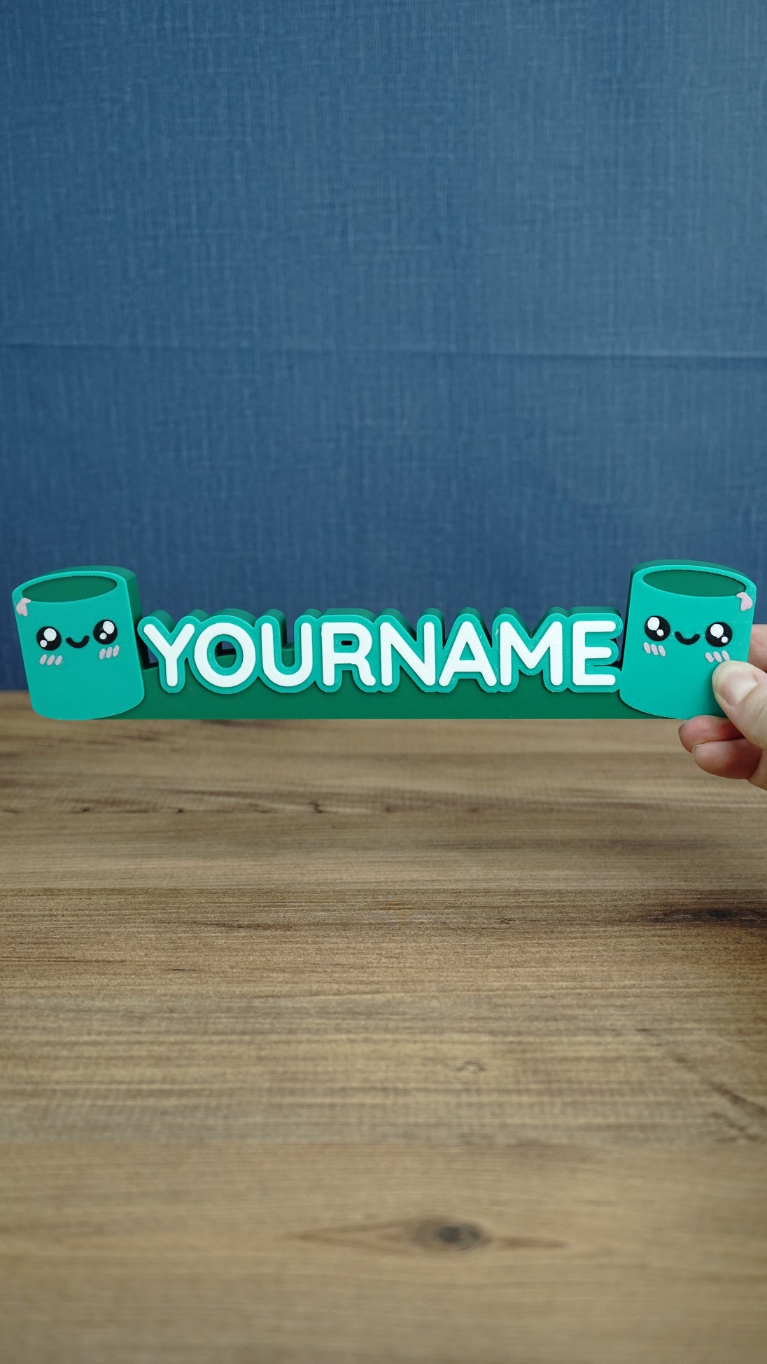 Front view of personalized Palia Cyl-inspired name sign with two cute green cylinder characters, designed as a custom gamer desk decoration