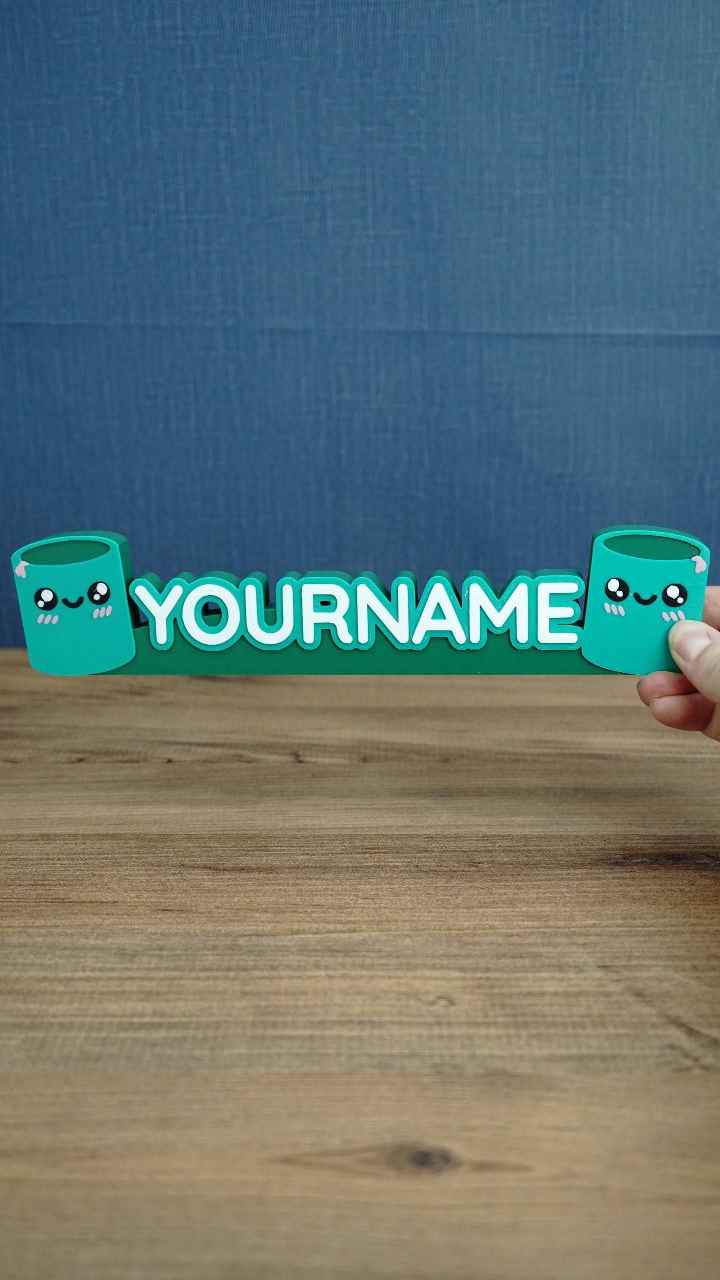 Front view of personalized Palia Cyl-inspired name sign with two cute green cylinder characters, designed as a custom gamer desk decoration