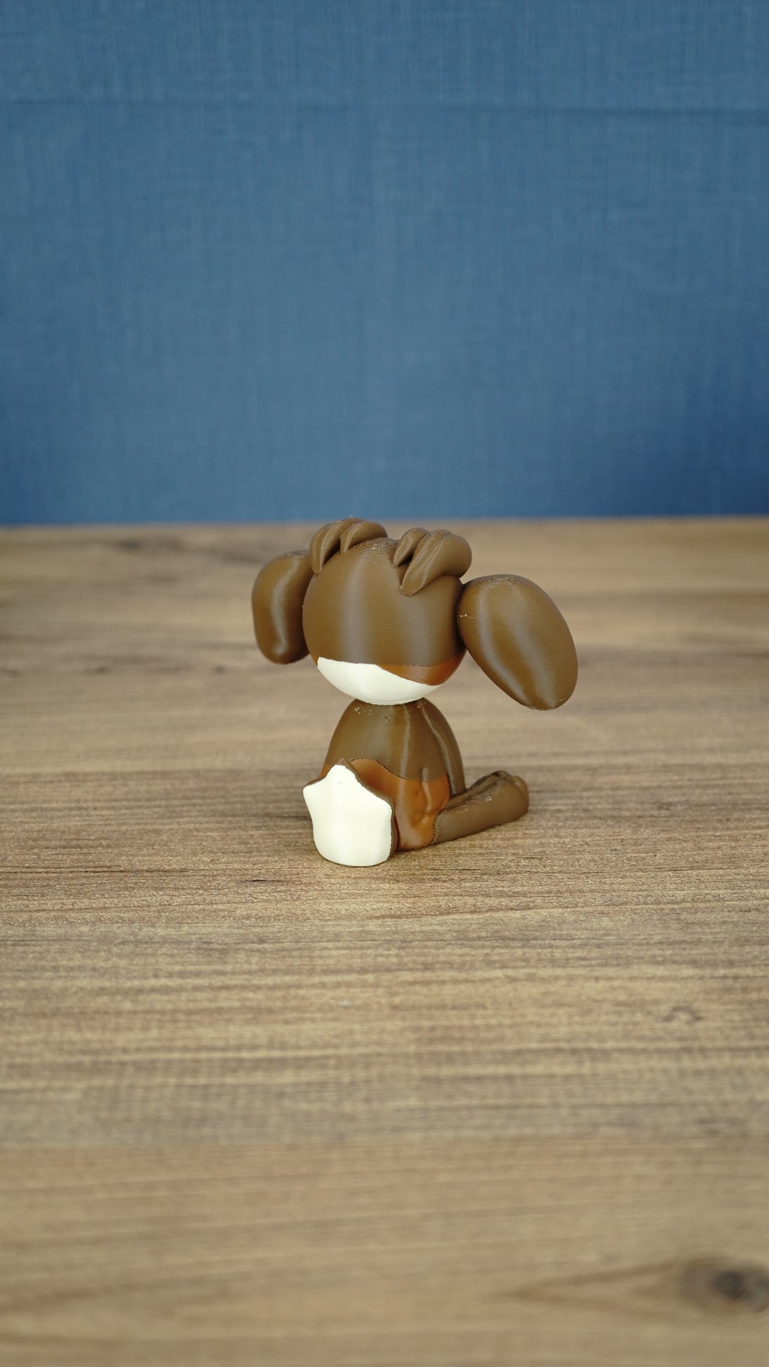 Rear view of the Elder Sernuk-inspired Palia plush figure showing its rounded head, ears, and cream tail.