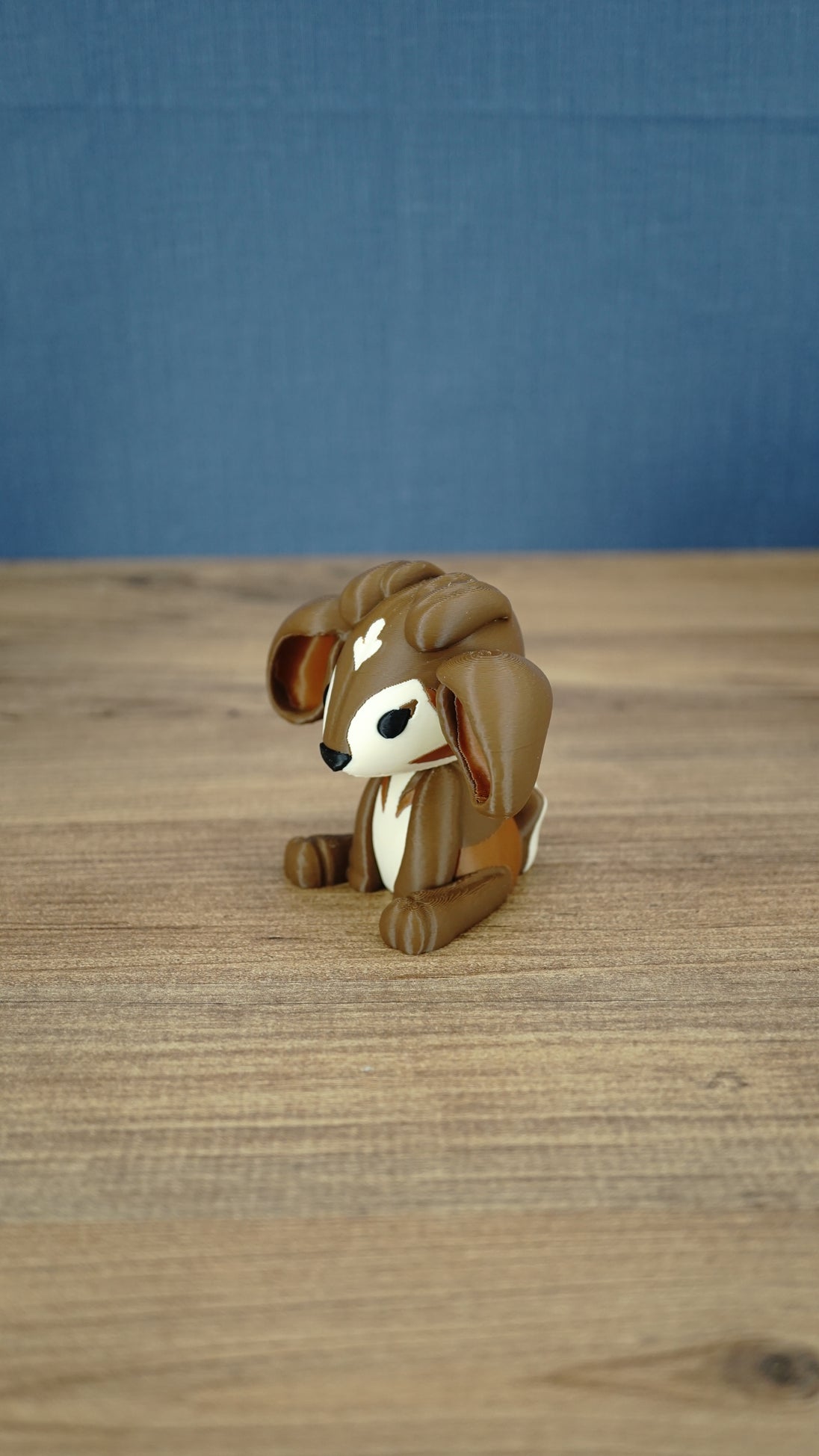 Side view of the Elder Sernuk-inspired Palia plush figure showing its large ears and seated pose.