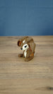 Side view of the Elder Sernuk-inspired Palia plush figure showing its large ears and seated pose.
