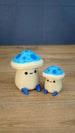 Large and small Elderwood Fun Guy figurines with bright blue mushroom caps, dark blue spots, cream bodies, and blue feet.
