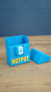 Empty blue Palia Hotpot storage box with gold Hotpot lettering and white pass token detail, shown open with its lid beside it.