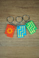 Close-up of Factorio circuit keyring showing orange embossed design