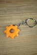 Factorio gear cog displayed on gaming desk setup