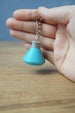 Close-up of Factorio science flask keyring showing embossed detail