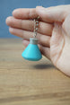 Close-up of Factorio science flask keyring showing embossed detail