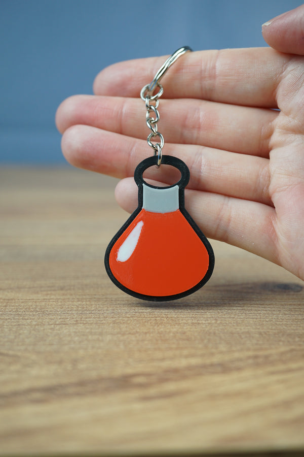 Close-up of Factorio science keyring showing embossed detail