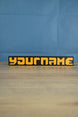 Factorio style nameplate 3D printed with orange text and black backplate