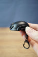 Handheld FAST MT helmet bottle opener keychain with black tactical helmet styling, side rail details, and attached black keyring clip.
