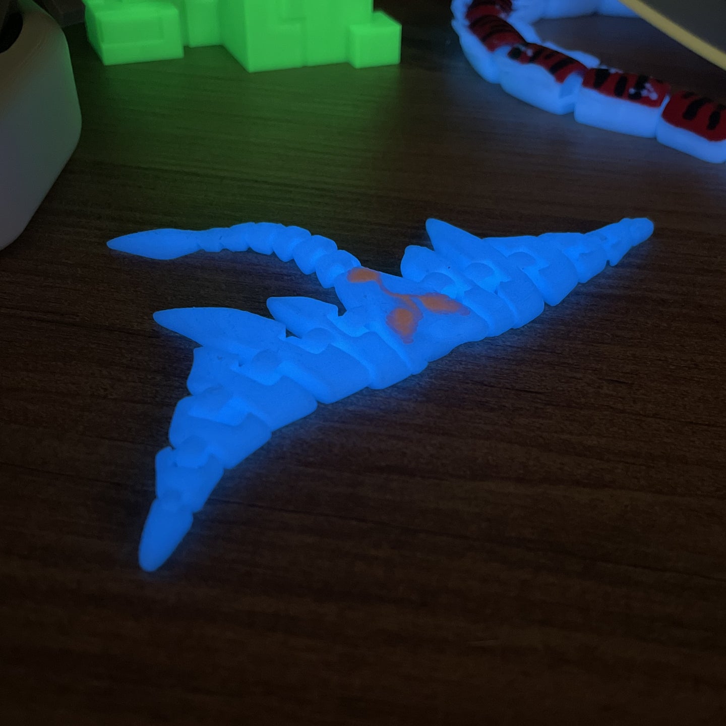 Glow-in-the-dark Subnautica Ghostray toy on shelf