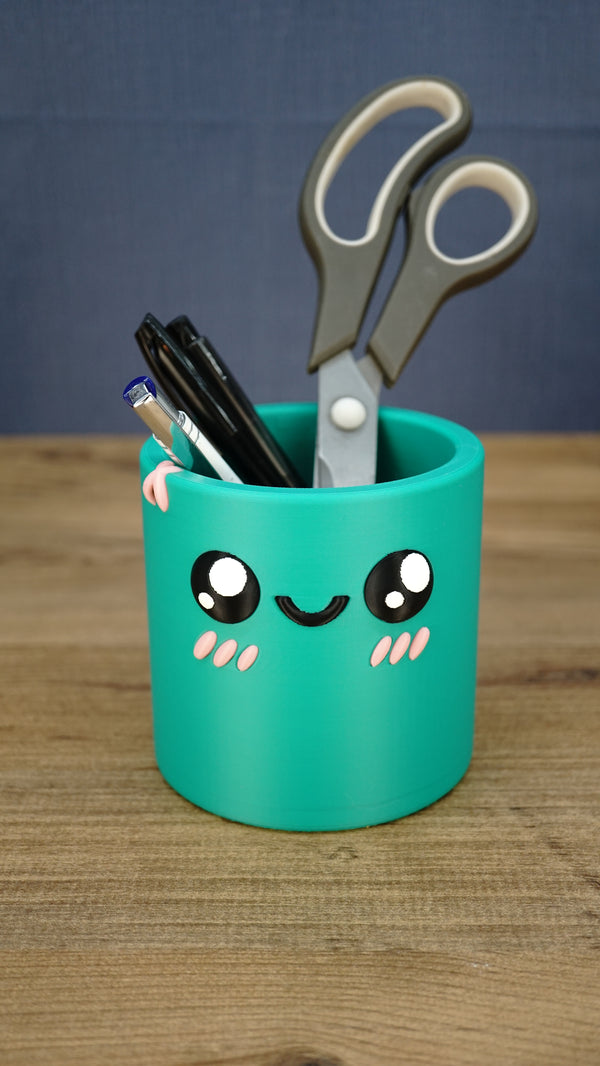 Green Cyl pen pot holding pens and scissors, demonstrating its use as a cute Palia-inspired stationery organiser for a desk, office or craft room.
