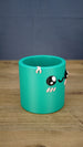 Right-side view of the green Palia-inspired Cyl pencil holder, highlighting the character face, pink rim detail and smooth rounded container shape.