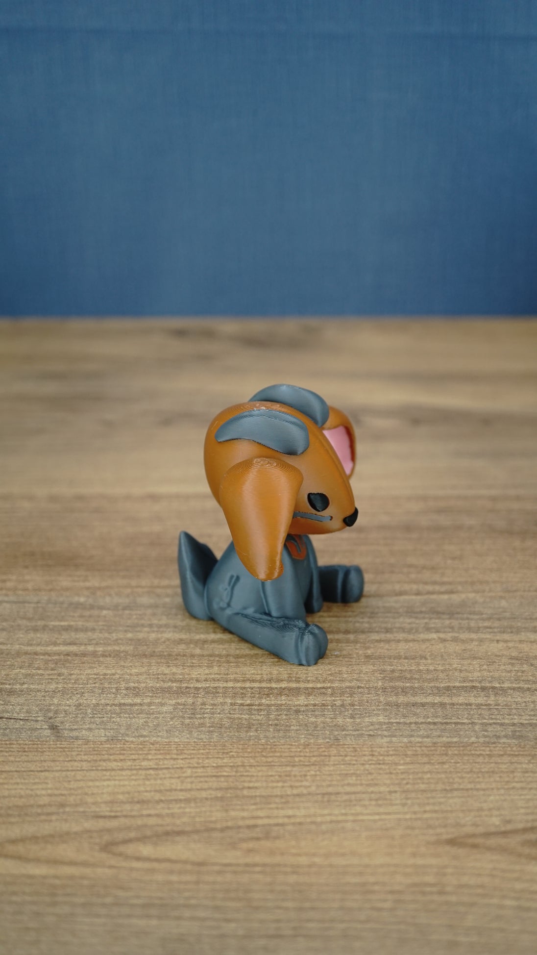 Side view of the Highlands Sernuk-inspired plush figure showing its blue ears and seated pose.