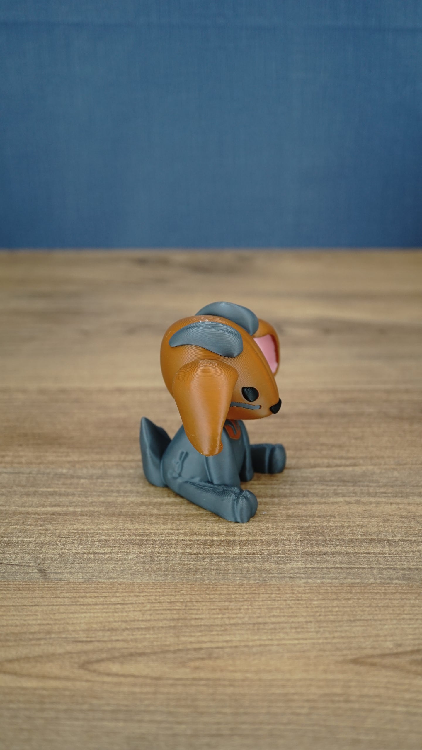 Side view of the Highlands Sernuk-inspired plush figure showing its blue ears and seated pose.