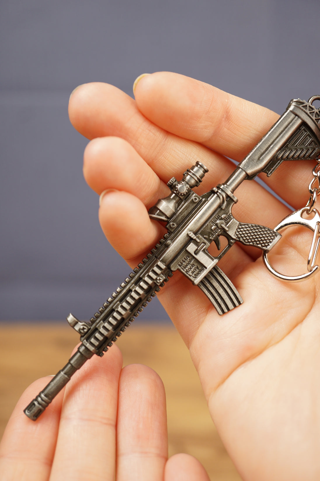 Detailed HK 416A5 rifle keyring replica in hand with tactical FPS gaming style, matte black metal finish and collector keychain design