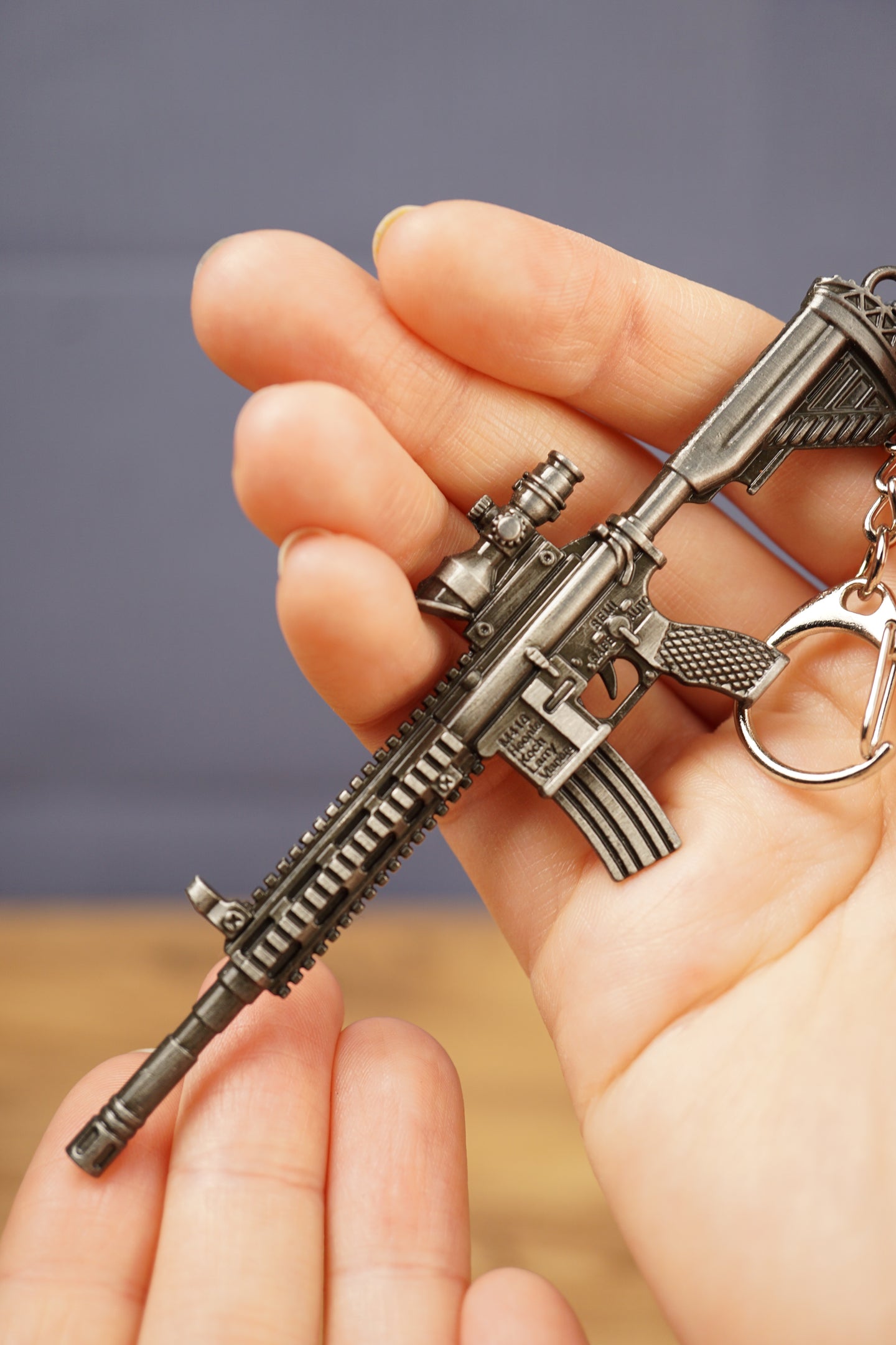 Detailed HK 416A5 rifle keyring replica in hand with tactical FPS gaming style, matte black metal finish and collector keychain design