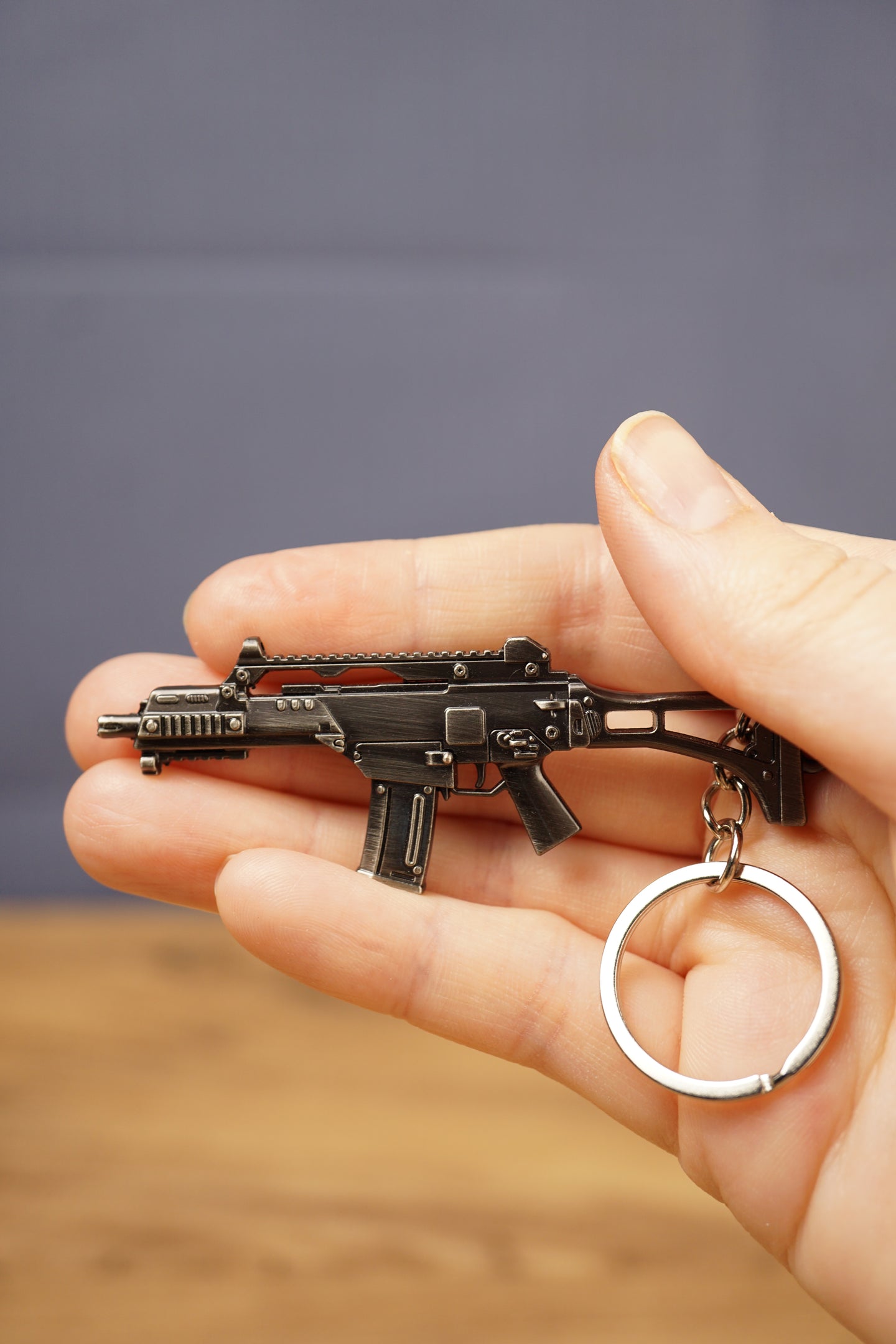 HK G36 rifle keyring held in hand with silver keyring attached, collectible metal gamer accessory for FPS players