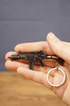 HK G36 rifle keyring held in hand with silver keyring attached, collectible metal gamer accessory for FPS players
