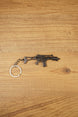HK G36 metal rifle keyring laid flat on a wood surface, detailed tactical FPS gamer keychain with silver ring and chain