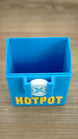 Top view inside the empty blue Palia Hotpot storage box, showing the open compartment and front pass token detail.