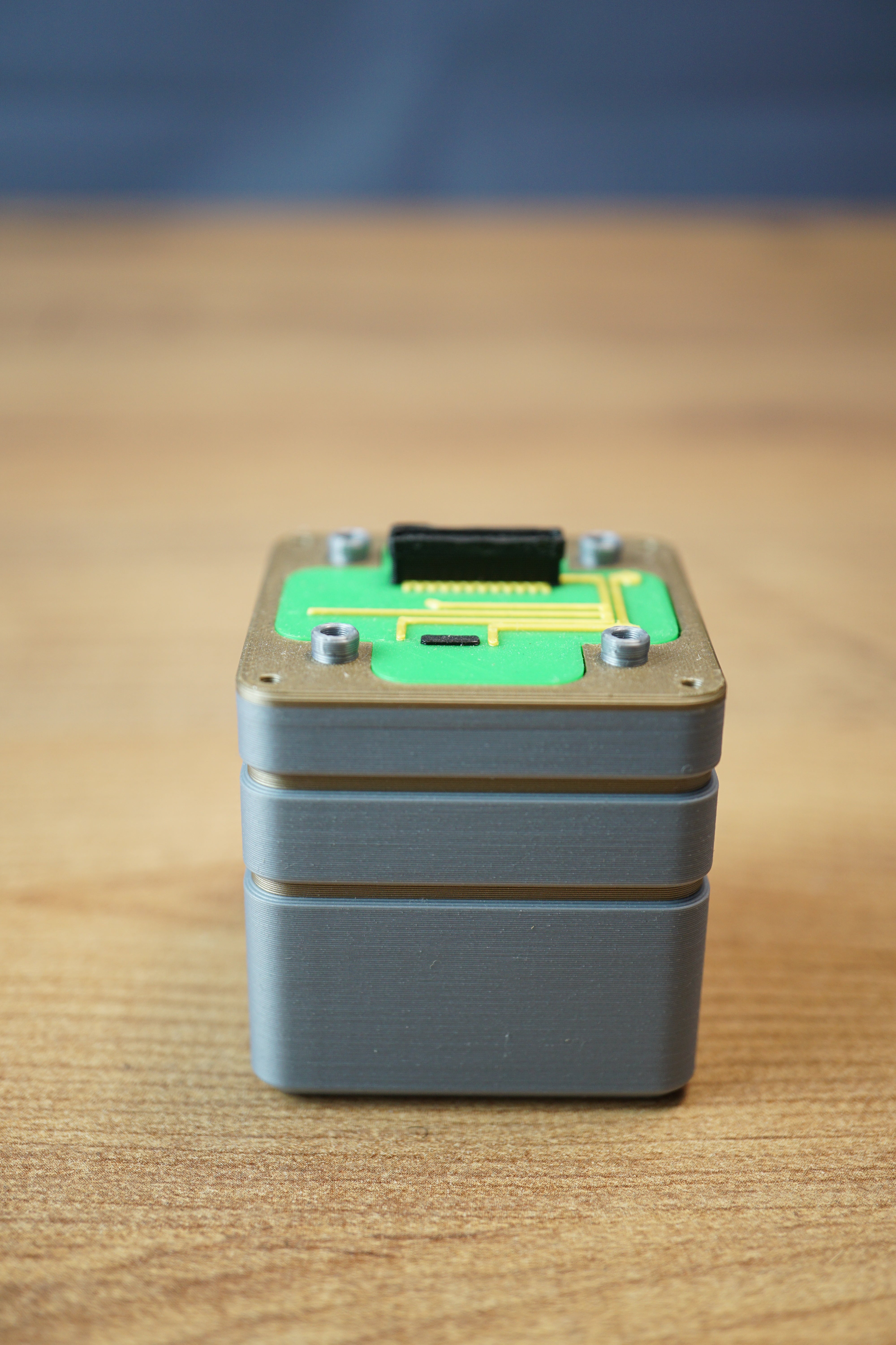 Iridium thermal vision module replica inspired by Tarkov, shown from the front with grey body, green circuit detail, and black top connector.