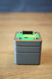 Iridium thermal vision module replica inspired by Tarkov, shown from the front with grey body, green circuit detail, and black top connector.