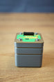 Iridium thermal vision module replica inspired by Tarkov, shown from the front with grey body, green circuit detail, and black top connector.