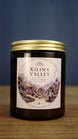 Kilima Valley vegan soy wax candle in an amber glass jar with gold lid, featuring cosy cashmere and soft amber fragrance.