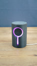 Knowledge Stone RGB LED gaming light illuminated purple around the circular centre and vertical light channel on a dark grey sci-fi body.