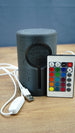 Knowledge Stone USB LED lamp displayed with its colour remote controller, USB cable and inline power switch on a wooden gaming desk.