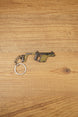KRISS Vector Gen 2 SMG keychain lying flat on a wooden surface with metal keyring attached, ideal tactical gaming gift for FPS fans